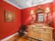 Powder room with red walls, decorative mirror, and single vanity at 100 Blue Lake Ct, Longwood, FL 32779