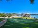 Backyard putting green next to the lake with a boat dock at 100 Blue Lake Ct, Longwood, FL 32779