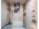 Walk-in shower in the primary bathroom with marble tile, bench, and multiple shower heads at 100 Blue Lake Ct, Longwood, FL 32779