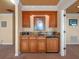 Wet bar with wooden cabinetry and granite countertops at 100 Blue Lake Ct, Longwood, FL 32779