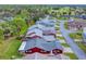 Aerial view of a red house with gray roof and surrounding homes at 11 Fore Dr, New Smyrna Beach, FL 32168