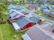 Aerial view of a red house with gray roof and backyard at 11 Fore Dr, New Smyrna Beach, FL 32168