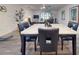 Dining area with a marble table and black leather chairs at 11 Fore Dr, New Smyrna Beach, FL 32168