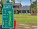Golf course sign with house in background at 11 Fore Dr, New Smyrna Beach, FL 32168