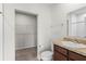 Bathroom with toilet, sink, vanity, and walk-in closet at 1224 Golden Eagle Ln, Winter Haven, FL 33880