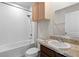 Bathroom with shower/tub combo, vanity, and wood cabinet at 1224 Golden Eagle Ln, Winter Haven, FL 33880