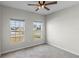 Bright bedroom with two windows, ceiling fan, and neutral walls at 1224 Golden Eagle Ln, Winter Haven, FL 33880