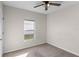 Bedroom with ceiling fan, window, and carpet flooring at 1224 Golden Eagle Ln, Winter Haven, FL 33880