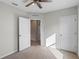 Bedroom with ceiling fan and access to bathroom and hallway at 1224 Golden Eagle Ln, Winter Haven, FL 33880