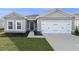Gray house with white garage door and dark blue front door at 1224 Golden Eagle Ln, Winter Haven, FL 33880