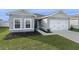 Gray house with white garage door and dark blue front door at 1224 Golden Eagle Ln, Winter Haven, FL 33880