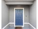 Inviting blue front door with a white frame and a welcome mat at 1224 Golden Eagle Ln, Winter Haven, FL 33880