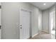 Bright hallway with tiled floor and doors to other rooms at 1224 Golden Eagle Ln, Winter Haven, FL 33880