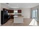 Modern kitchen with dark wood cabinets and an island at 1224 Golden Eagle Ln, Winter Haven, FL 33880