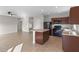 Modern kitchen with island, dark wood cabinets and black appliances at 1224 Golden Eagle Ln, Winter Haven, FL 33880