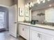 Double vanity bathroom with modern finishes and plenty of light at 1670 Moon Valley Dr, Davenport, FL 33896