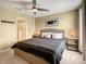 Bedroom with a gray and beige bedding set and an ensuite bathroom at 1670 Moon Valley Dr, Davenport, FL 33896