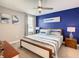 King bedroom with coastal decor and blue accent wall at 1670 Moon Valley Dr, Davenport, FL 33896