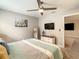 King bedroom with TV, dresser, and ensuite access at 1670 Moon Valley Dr, Davenport, FL 33896