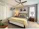 Bedroom with a yellow and gray bedding set and a ceiling fan at 1670 Moon Valley Dr, Davenport, FL 33896