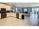 Modern kitchen with white cabinets, stainless steel appliances, and an open floor plan at 1670 Moon Valley Dr, Davenport, FL 33896