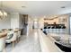 Open concept living area with a white couch, kitchen island, and dining table at 1670 Moon Valley Dr, Davenport, FL 33896
