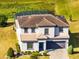 Two-story house with tile roof and a two-car garage at 181 Brookes Pl, Haines City, FL 33844