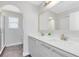 Elegant bathroom with double sinks, a large mirror, and a walk-in shower at 181 Brookes Pl, Haines City, FL 33844