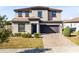 Two-story house with two-car garage and landscaping at 181 Brookes Pl, Haines City, FL 33844
