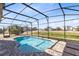 Refreshing screened pool with patio and lounge chairs at 181 Brookes Pl, Haines City, FL 33844