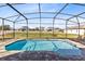 Relaxing screened pool with lounge chairs at 181 Brookes Pl, Haines City, FL 33844
