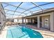 Inviting screened pool with patio and lounge chairs at 181 Brookes Pl, Haines City, FL 33844