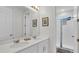 Bathroom with double vanity, large mirror, and walk-in shower at 1840 Caribbean View Ter, Kissimmee, FL 34747
