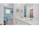 Shared bathroom with double vanity and a view into a bedroom at 1840 Caribbean View Ter, Kissimmee, FL 34747