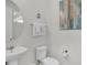Simple bathroom with a pedestal sink and toilet at 1840 Caribbean View Ter, Kissimmee, FL 34747