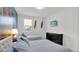 Beach-themed bedroom with twin beds, dresser, and wall art at 1840 Caribbean View Ter, Kissimmee, FL 34747