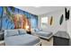 Bedroom with surf-themed mural, two twin beds, and a dresser at 1840 Caribbean View Ter, Kissimmee, FL 34747