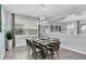 Modern dining room with a sleek table and six chairs at 1840 Caribbean View Ter, Kissimmee, FL 34747