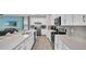 Modern kitchen with white cabinets, stainless steel appliances and a large island at 1840 Caribbean View Ter, Kissimmee, FL 34747