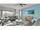 Living room with comfy seating, large TV, and view of the pool at 1840 Caribbean View Ter, Kissimmee, FL 34747
