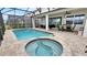Relaxing pool and spa with covered patio and outdoor seating at 1840 Caribbean View Ter, Kissimmee, FL 34747
