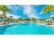 Large resort-style pool with lounge chairs and cabanas at 1840 Caribbean View Ter, Kissimmee, FL 34747