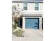 Front view of a townhome featuring a teal garage door at 2906 Fieldwood Cir, St Cloud, FL 34772