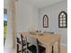 Light-filled dining area with a wood table, four chairs, and decorative wall accents at 3331 Private Oak Dr, Apopka, FL 32703