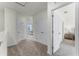 Bright hallway with carpet flooring and access to bedrooms at 3331 Private Oak Dr, Apopka, FL 32703