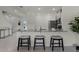 Kitchen island with granite countertop, three-person seating, and modern appliances at 3331 Private Oak Dr, Apopka, FL 32703