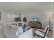 Open living space with kitchen island, contemporary sofa, and a wall-mounted TV at 3331 Private Oak Dr, Apopka, FL 32703