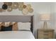 Main bedroom with a gray upholstered bed and unique wall decor at 3331 Private Oak Dr, Apopka, FL 32703