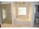 Elegant bathroom boasts a large soaking tub, walk-in shower, and updated fixtures at 772 Bear Creek Cir, Winter Springs, FL 32708