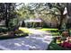 Brick home with landscaped yard and long driveway at 772 Bear Creek Cir, Winter Springs, FL 32708